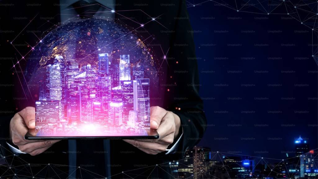 person holding laptop with whole city projecting from it