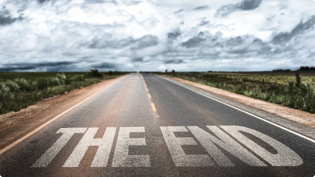 a road with writing saying the end painted on to it