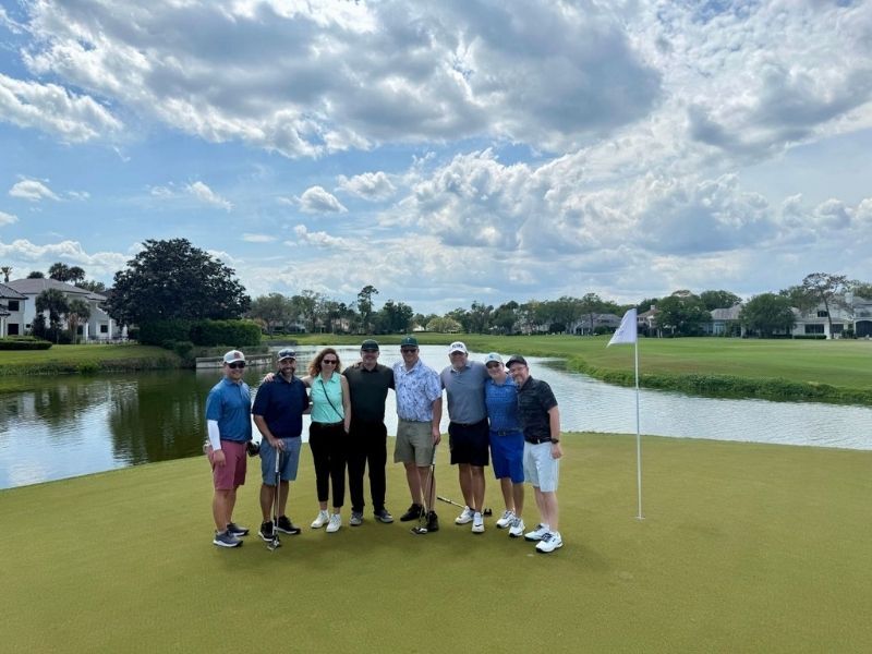 Aaron golfing with business group