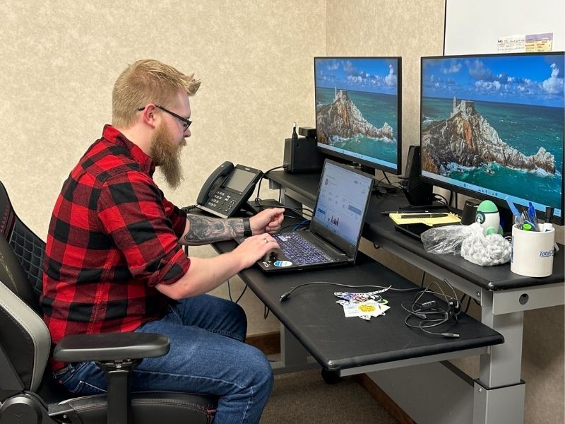 Chris working in TotalCare IT office
