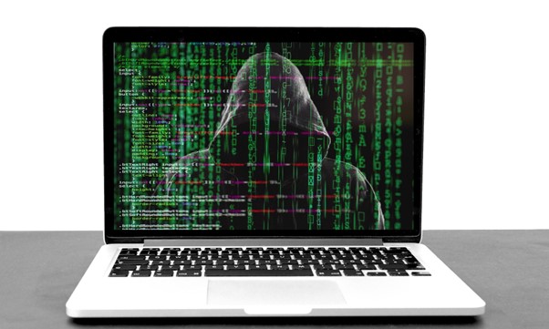 An anonymous hacker on the laptop screen