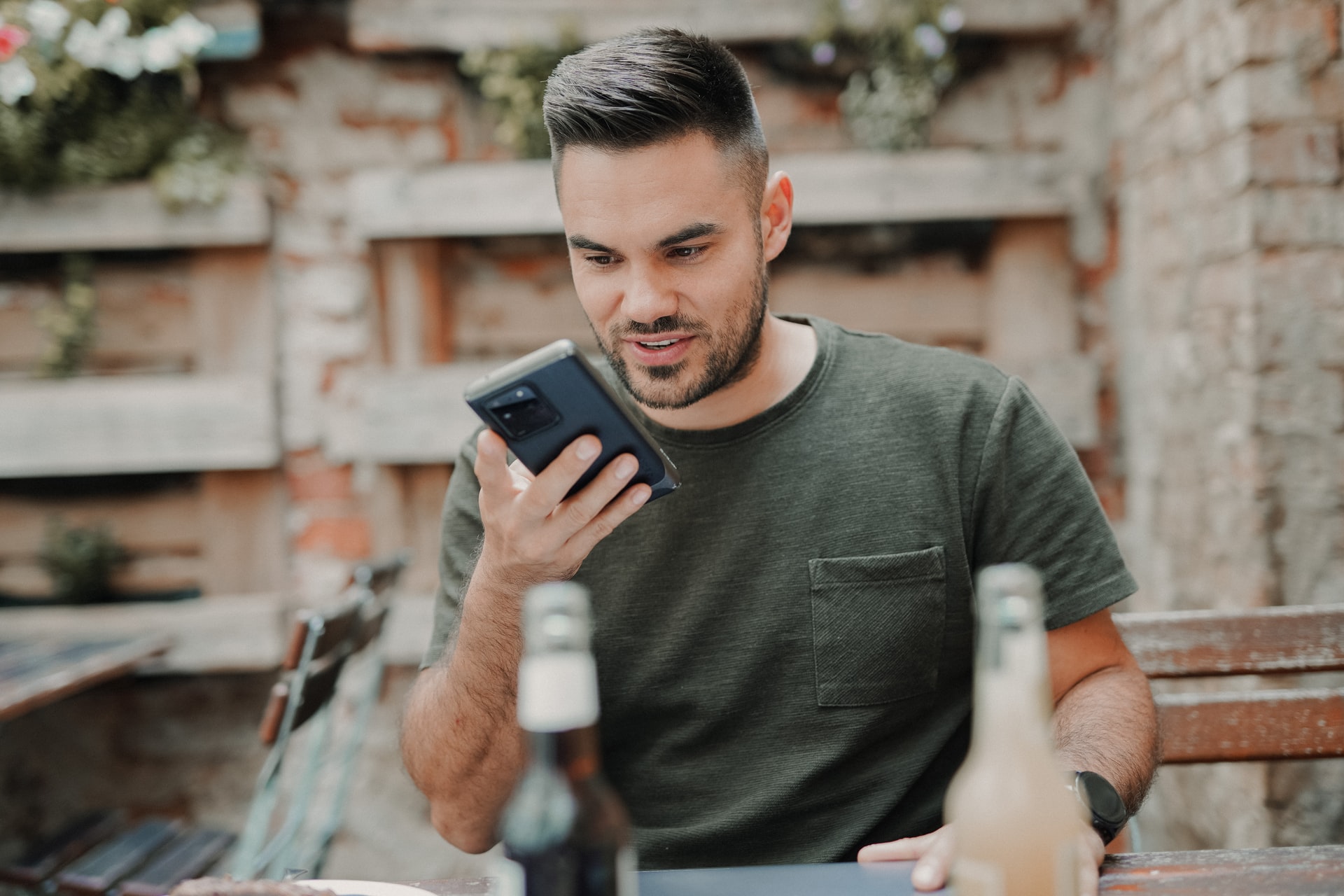 Man in green shirt on cell phone