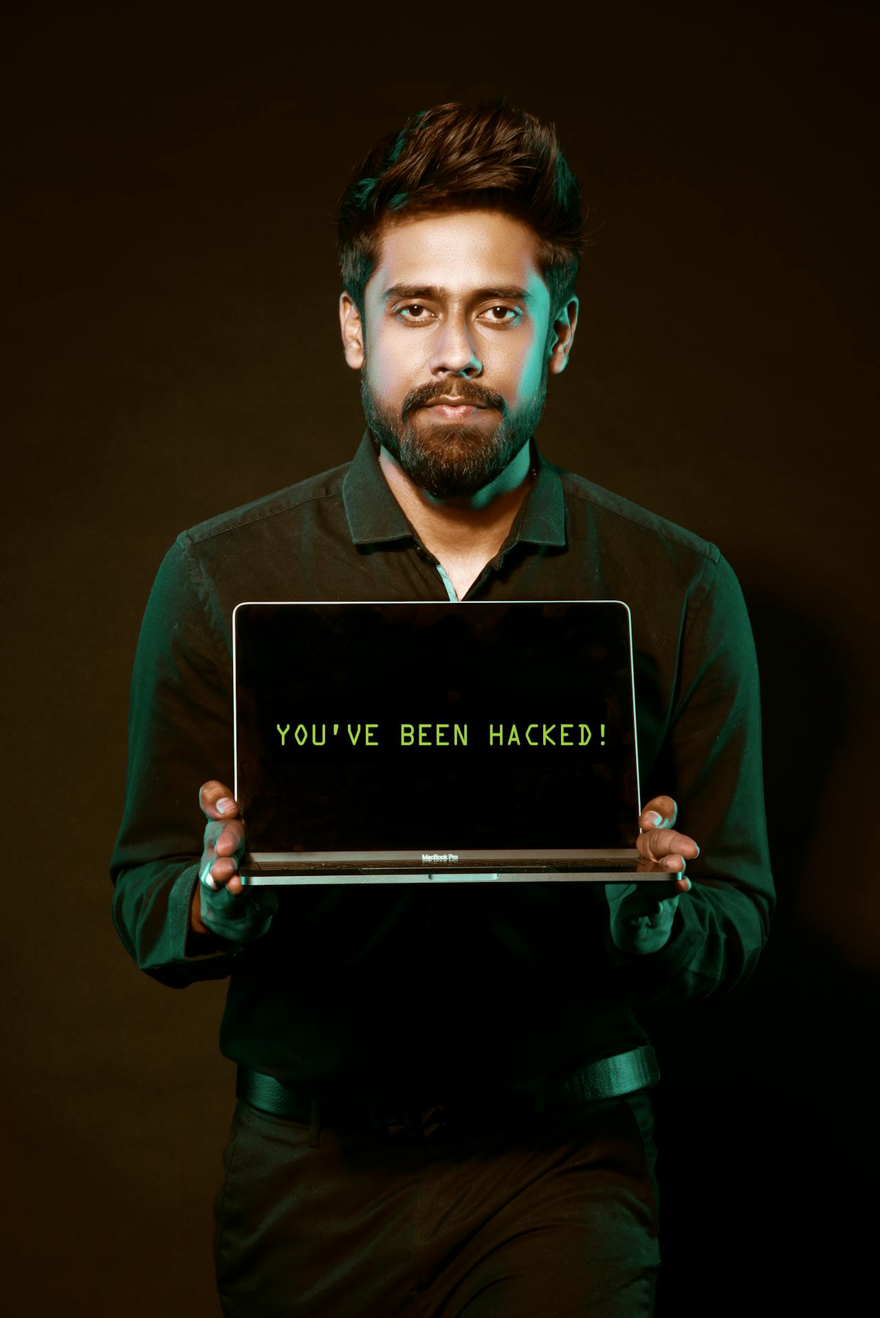 man holding laptop saying you were hacked