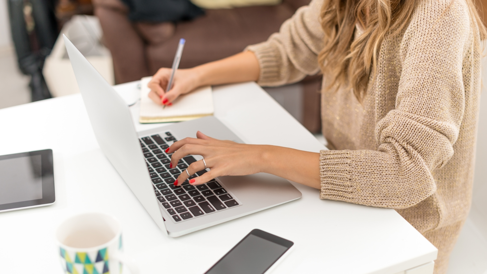 woman working remotely in living room with laptop